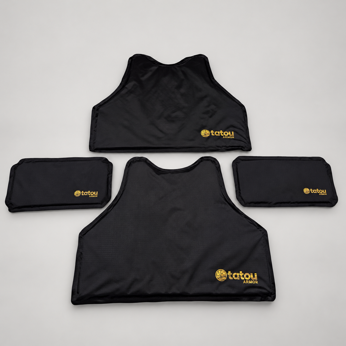 Four Tatou Armor QRS soft armor panels on a light studio background